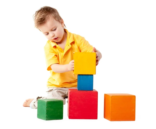 Little boy plays with cubes — Stock Photo, Image