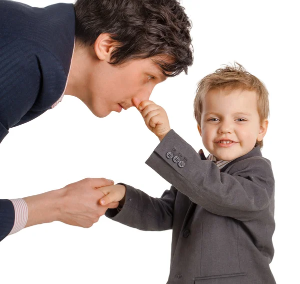 Happy boy holds his nose businessman on a white background — Stock Photo, Image
