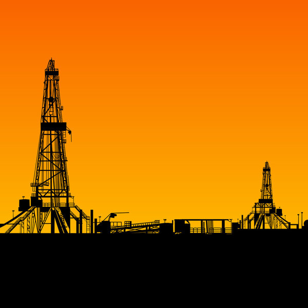 Oil rig silhouettes and orange sky