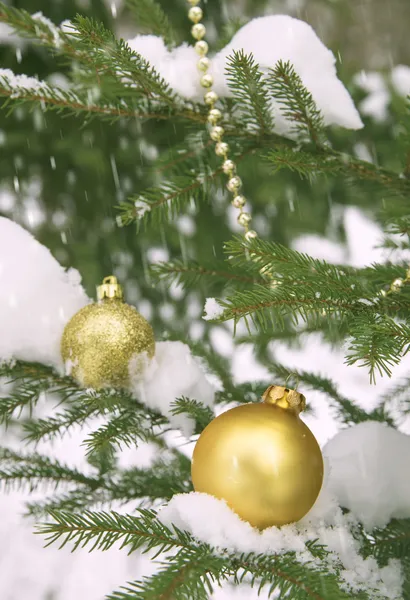 Toy ball and snowman over fir tree. — Stock Photo, Image