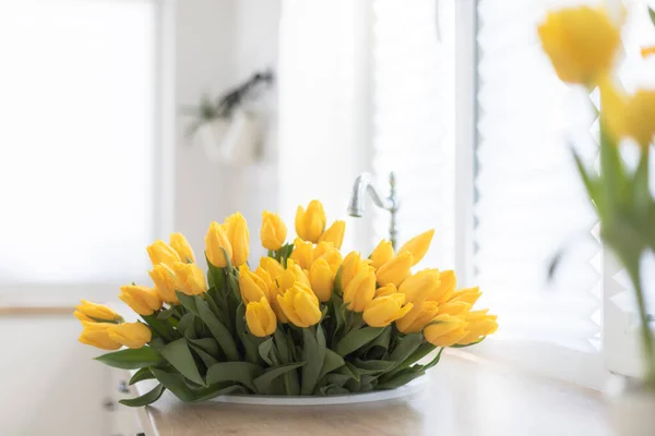 Kitchen interior with a fresh bouquet of tulips. — Stock Photo, Image