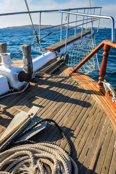 stem deck of a ship, with anchor and rope, walking on the sea to