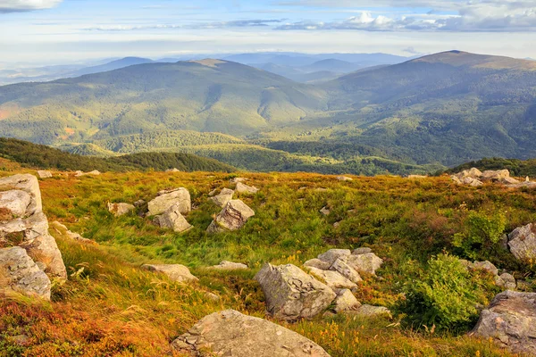 Mountain landscape with stones in the grass on hillside and blue — Stock Photo, Image