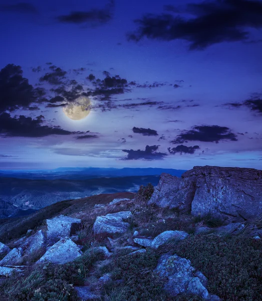 Light on stone mountain slope with forest at night — Stock Photo, Image