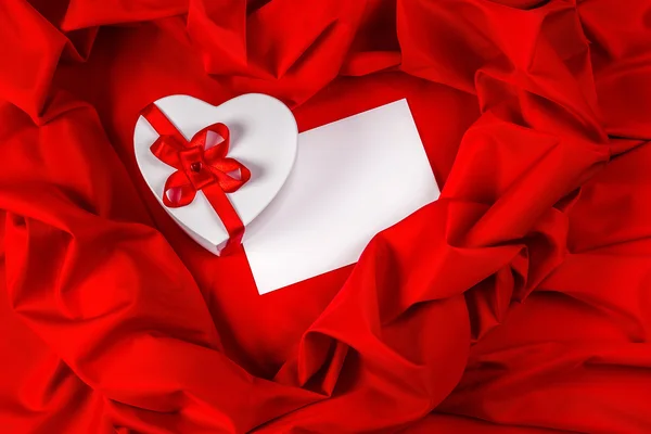 Love greeting card with heart on a red fabric — Stock Photo, Image
