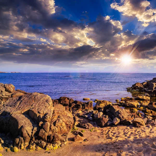 Sea waves breaking on the sandy beach at sunset — Stock Photo, Image