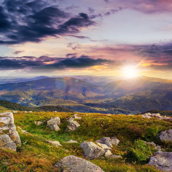 Light on stone mountain slope with forest at sunset — Stock Photo, Image