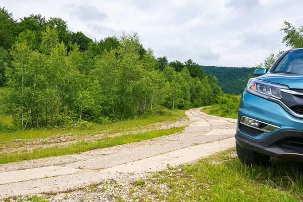 stock image likitsary, transcarpathia, ukraine - JUL 02, 2020: suv on the side of concrete road through forest. travel your back country concept