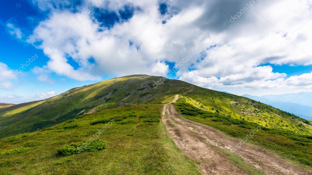 trail uphill the petros peak. beautiful summer landscape of carpathian mountains. success and achievement concept. grassy hill beneath a sky with clouds