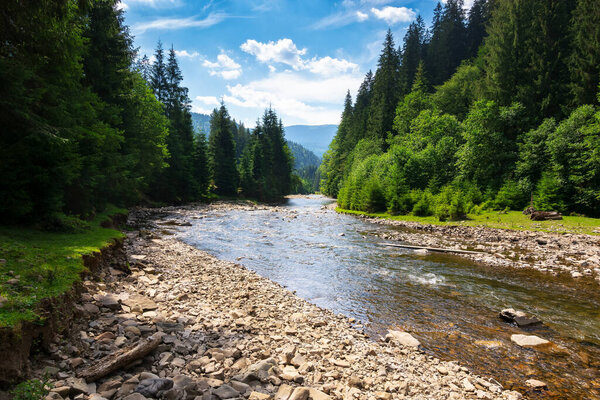 landscape with river running through valley. mountainous countryside scenery in summer. water flow along the rocky shore. sunny day with clouds on the blue sky