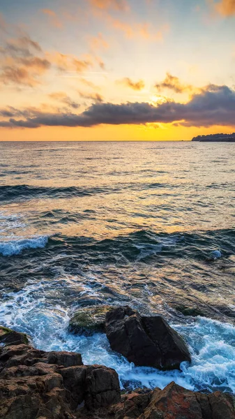 calm morning at the sea. nature scenery with rocky coast at dawn. clouds glowing on the sky. scenic picture-postcard view. black sea, bulgaria, europe