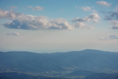 alpine meadows of runa mountain. stunning countryside landscape of trascarpathia in evening light. hill rolling down in to the distance. valley beneath a sky with beautiful cloudscape