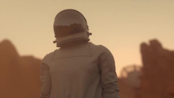 Astronaut auf dem Planeten Mars bei Sonnenuntergang. Zukunftskonzept Reisen — Stockvideo