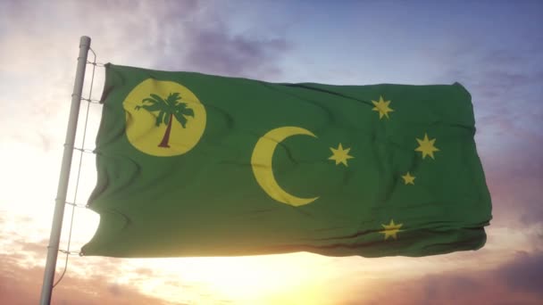 Terület Cocos vagy Keeling-szigetek zászló, Olaszország, integetett a szél, ég és a nap háttér — Stock videók