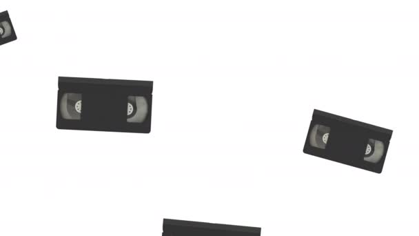 Retro video cassette tape falling down on white background — Stock Video