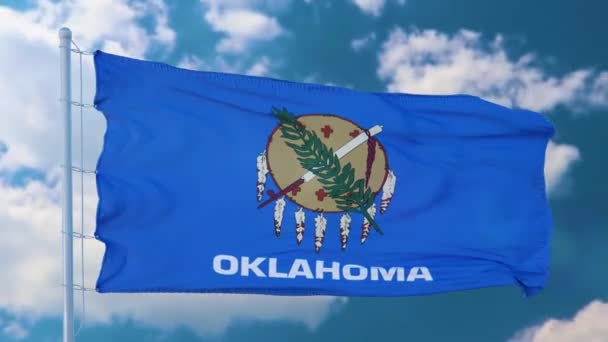 Oklahoma flagga på en flaggstång vinka i vinden, blå himmel bakgrund — Stockvideo