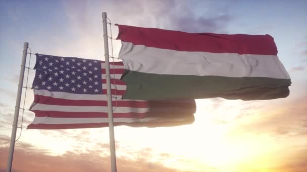 Maďarsko a vlajka Spojených států na vlajkovém stožáru. Maďarsko a USA mávají vlajkou ve větru. Maďarská a americká diplomacie — Stock video