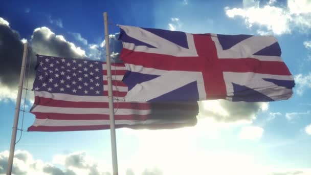 英国和美国国旗挂在旗杆上 美国和英国在风中飘扬国旗 美国和大不列颠及北爱尔兰联合王国的外交概念 — 图库视频影像