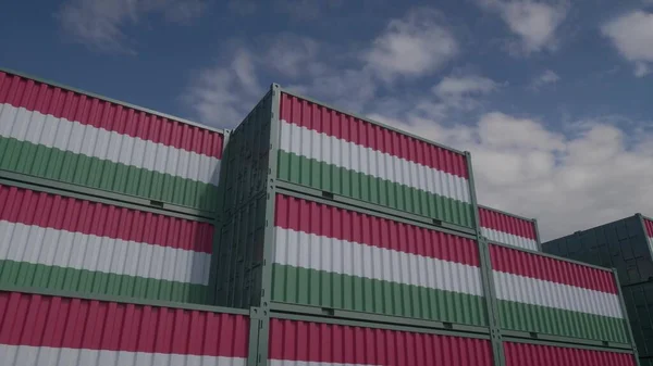 Hungary flag containers are located at the container terminal. Hungary export or import concept, 3d illustration.