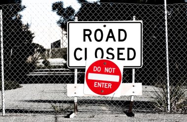 Road Closed Sign Before Chain Link Fence clipart