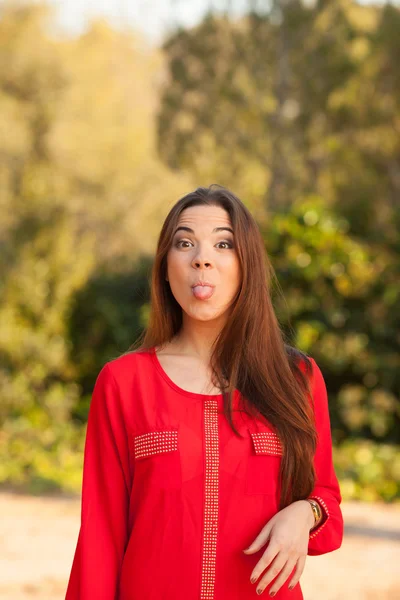 Young beautiful woman makes funny face — Stock Photo, Image