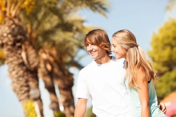 Young romantic beautiful couple enjoying on a walkside — Stock Photo, Image