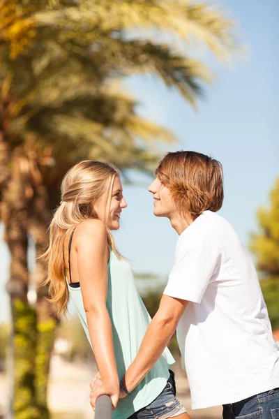 Young romantic beautiful couple enjoying on a walkside — Stock Photo, Image