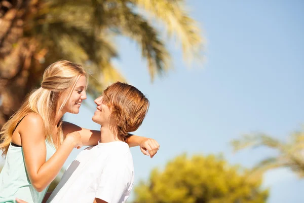 Young romantic beautiful couple enjoying on a walkside — Stock Photo, Image