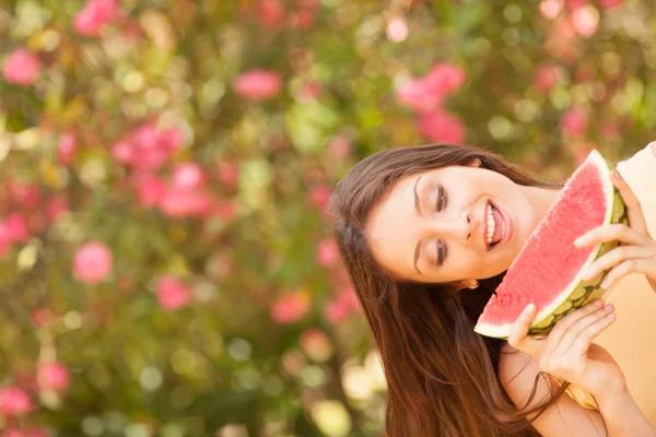 Porträtt av en vacker ung kvinna äta vattenmelon — Stockfoto