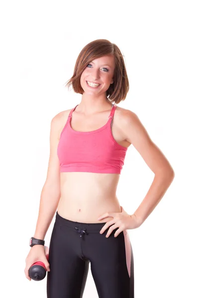 Young beautiful sport woman standing with a bottle isolated on w — Stock Photo, Image