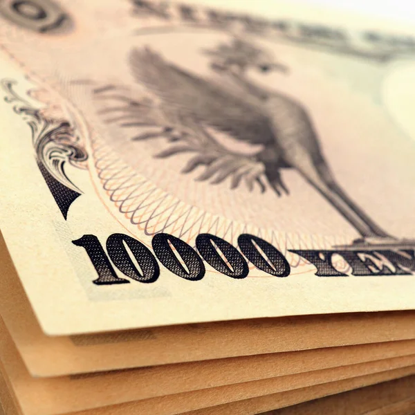 日本の1万円札の束 描かれたフェニックスの鳥と紙幣 図に焦点を当てます 日本経済をテーマにしたスクエアなイラスト マクロ — ストック写真