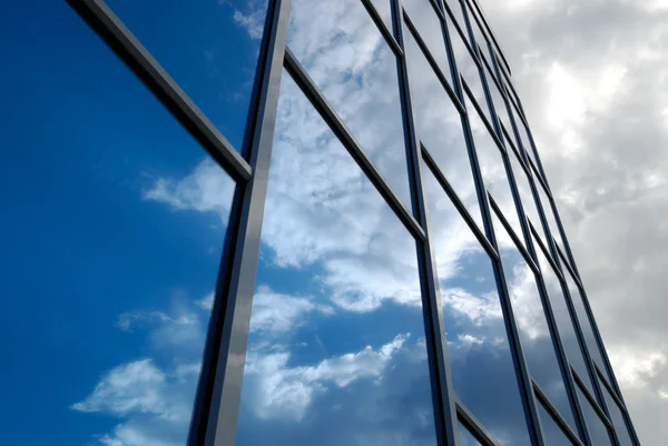 Fasada budynku z niebieskiego szkła odzwierciedla niebo — Zdjęcie stockowe