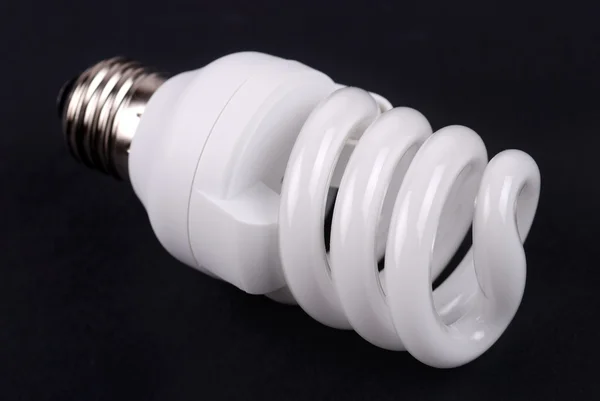 Energy saving bulb on black — Stock Photo, Image