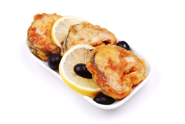 Fried fish with a lemon and olives — Stock Photo, Image