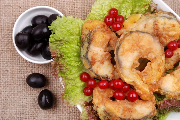 The served dish from fish, salad, olives and a cranberry — Stock Photo, Image