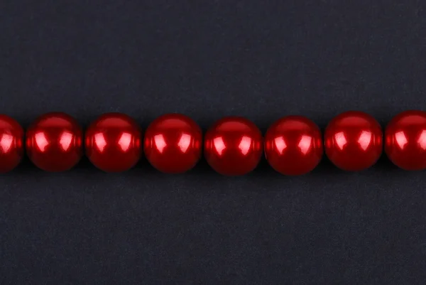 Red beads on a black — Stock Photo, Image