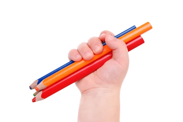 The children's hand holds colour pencils — Stock Photo, Image