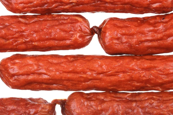 Fond de savoureuses saucisses sur fond blanc — Photo