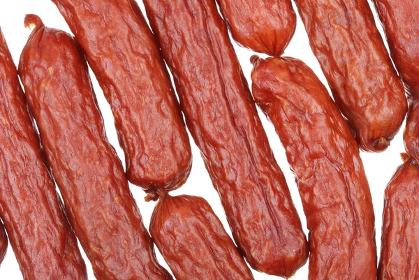 Fond de savoureuses saucisses sur fond blanc — Photo