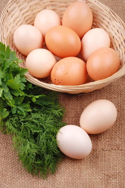 Basket with eggs on sackcloth — Stock Photo, Image