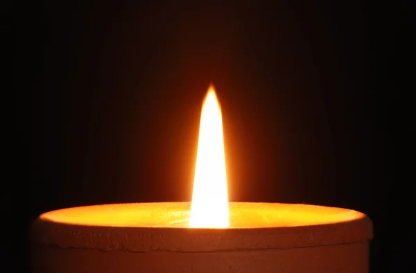 Burning candle isolated on black — Stock Photo, Image