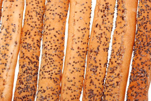 Palitos de pan salados con semillas de amapola aisladas en blanco —  Fotos de Stock