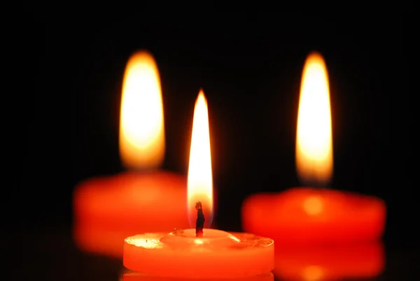 Burning candles on black background — Stock Photo, Image