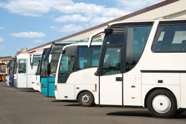 Tourist buses on a parking clipart