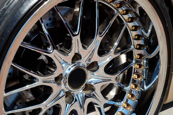 The chromeplated rim of a wheel