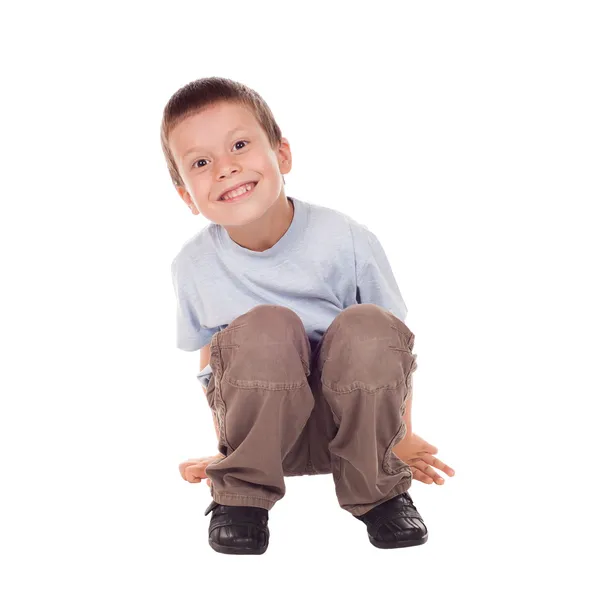 Lycklig pojke sitta ner — Stockfoto