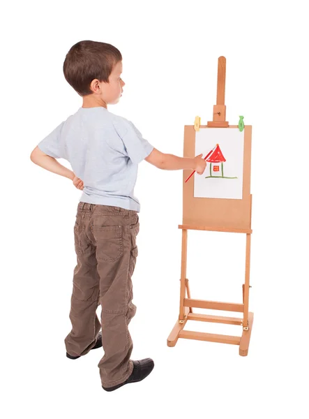 Boy paints house on easel Royalty Free Stock Photos