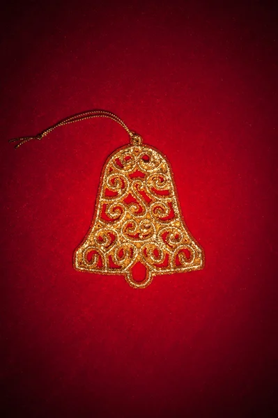 Christmas golden bell on red — Stock Photo, Image