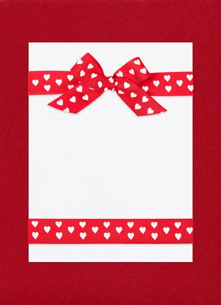 Red bow on paper sheet — Stock Photo, Image