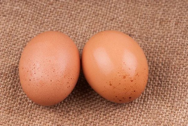 Eggs on sackcloth — Stock Photo, Image